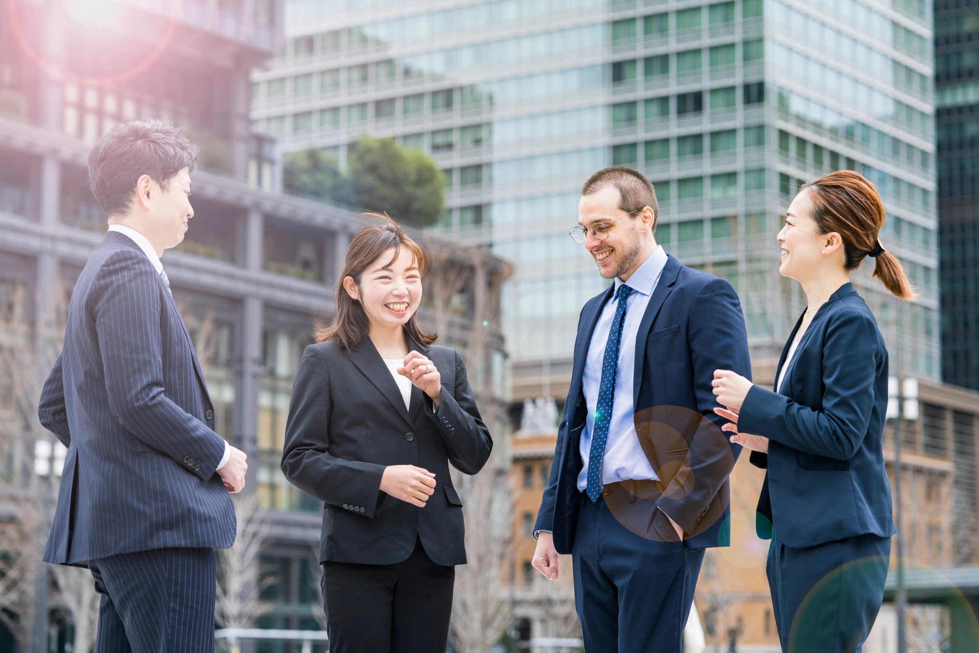 「ダイバーシティ」のイメージ_笑顔で会話する多様性のある社員